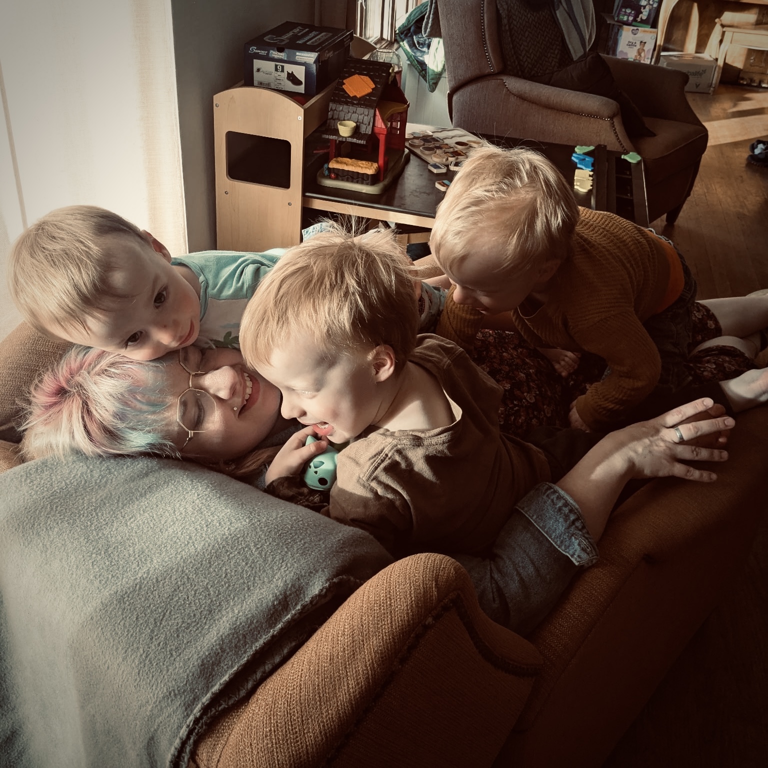Abbi cuddling on the couch with her three boys
